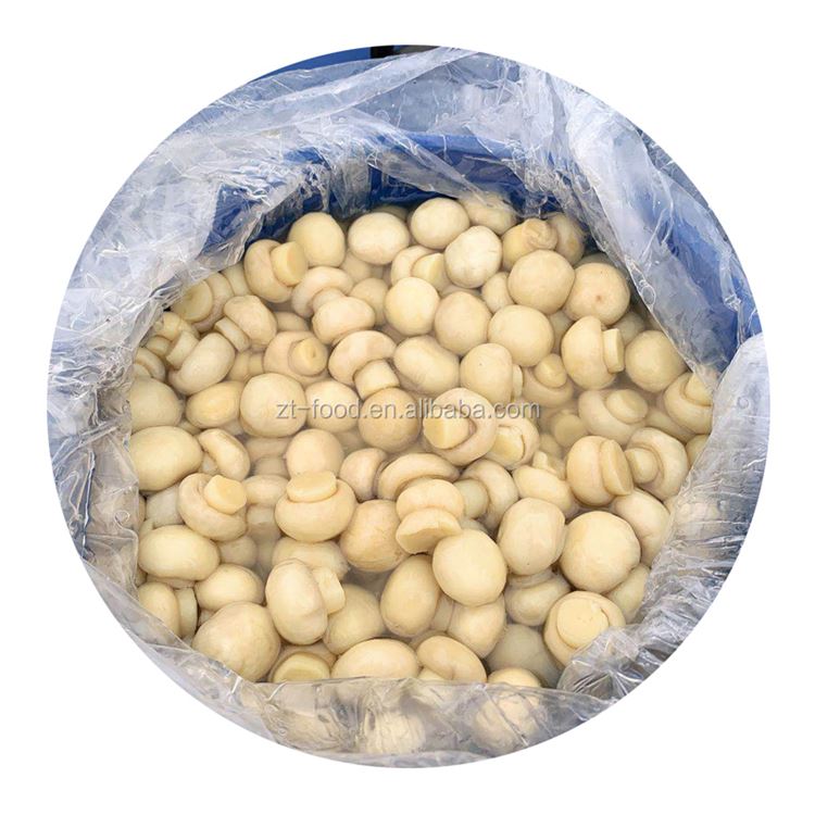 Whole white champignon mushroom in brine in drums